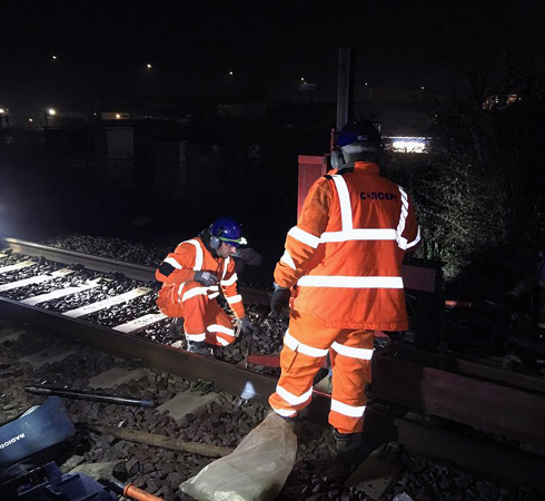 Two site operatives during a night shift of work on a train track 
