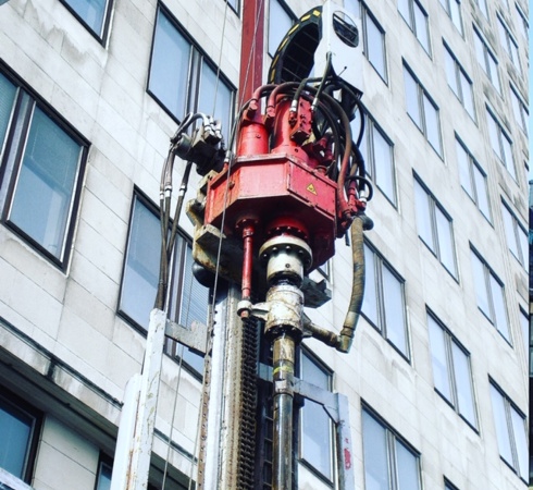 Rotary rig set up on site in front of a building